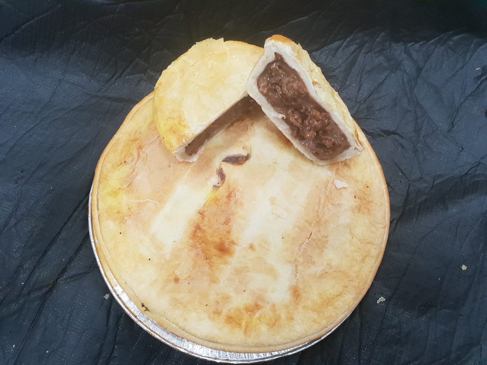 Simply Pies Family Pie cut open showing rich savoury beef filling, freshly baked golden pastry